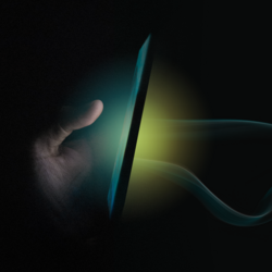 phone in the dark, lit on both sides by a green and yellow light