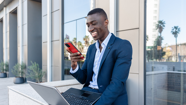Man on phone while working on laptop